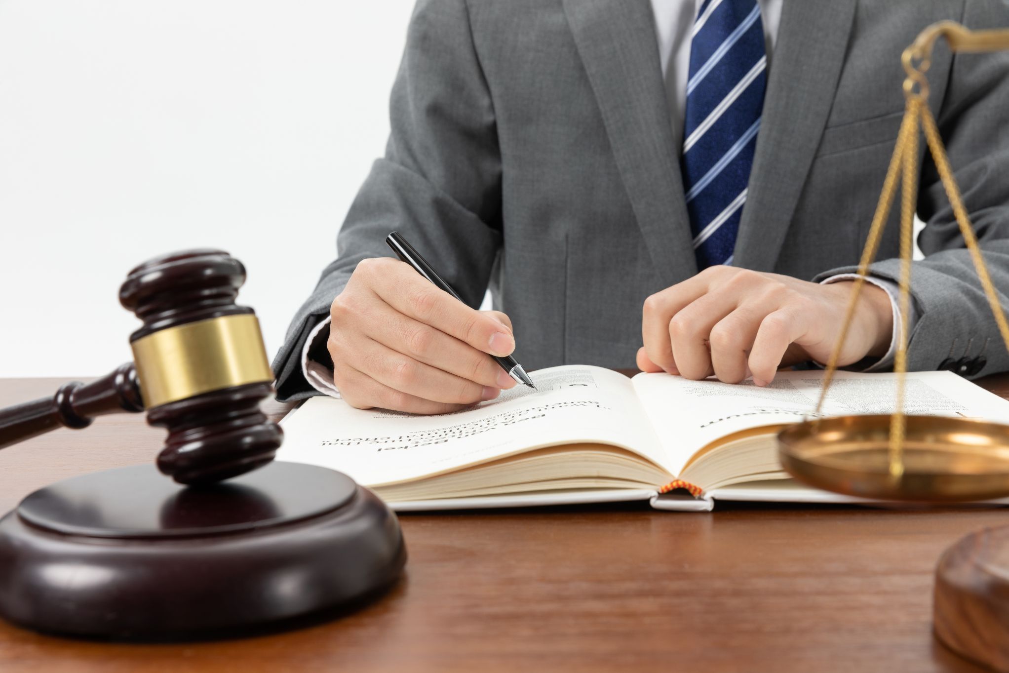 closeup-shot-person-writing-book-with-gavel-table-1